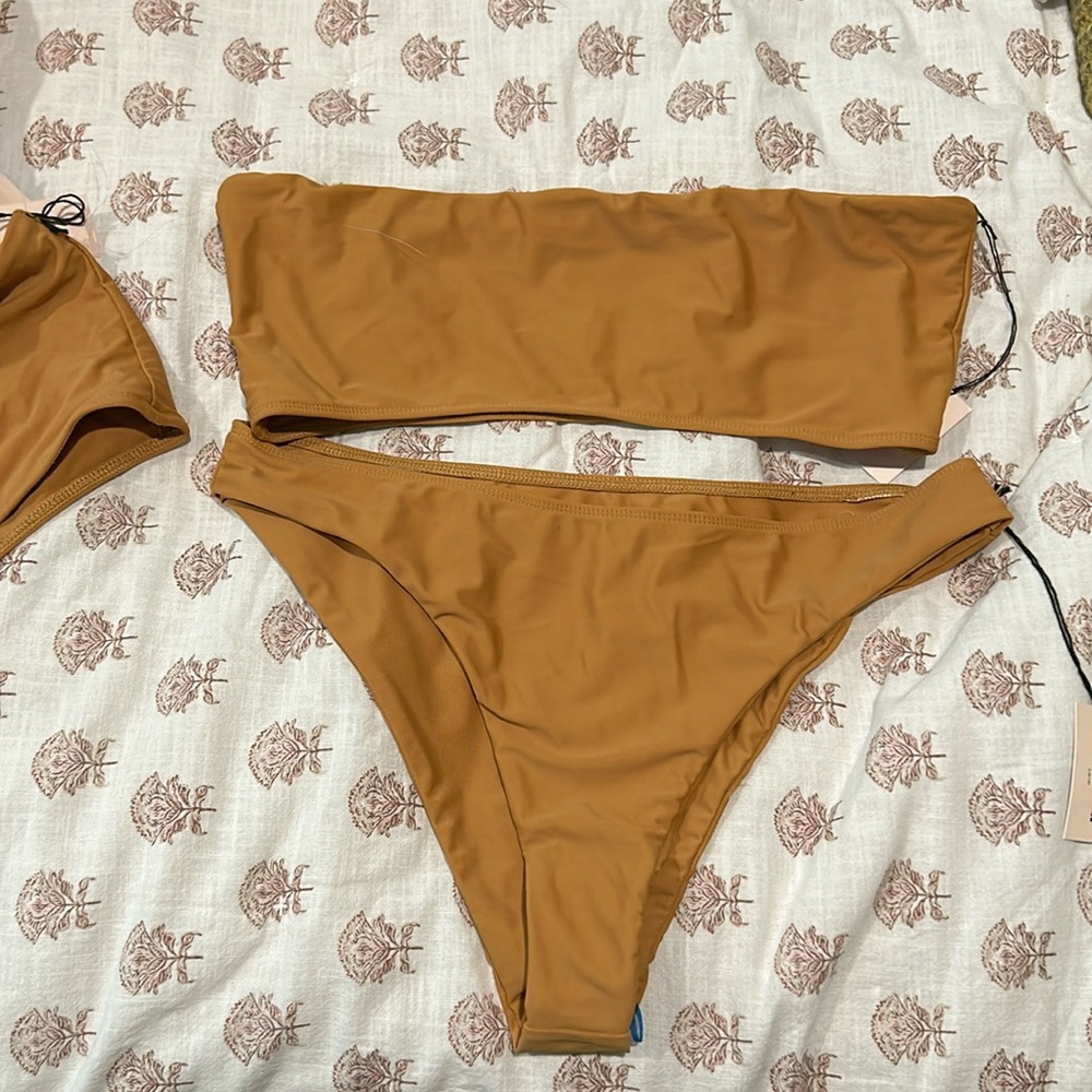 2 tops, size xl and large, with bottoms size xl, never worn with tags swimsuit.